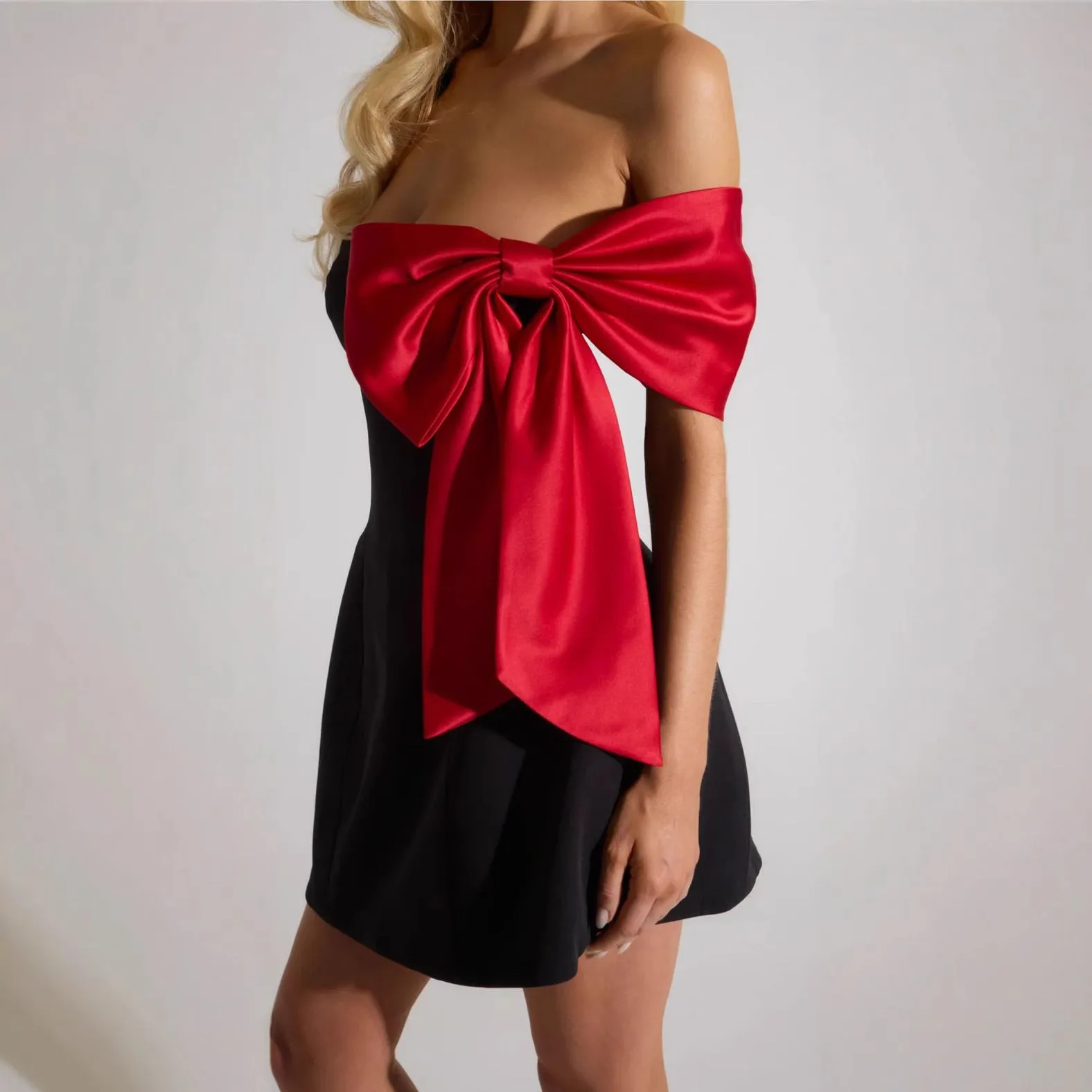 Elegant Off-Shoulder Dress with Dramatic Red Bow Accent