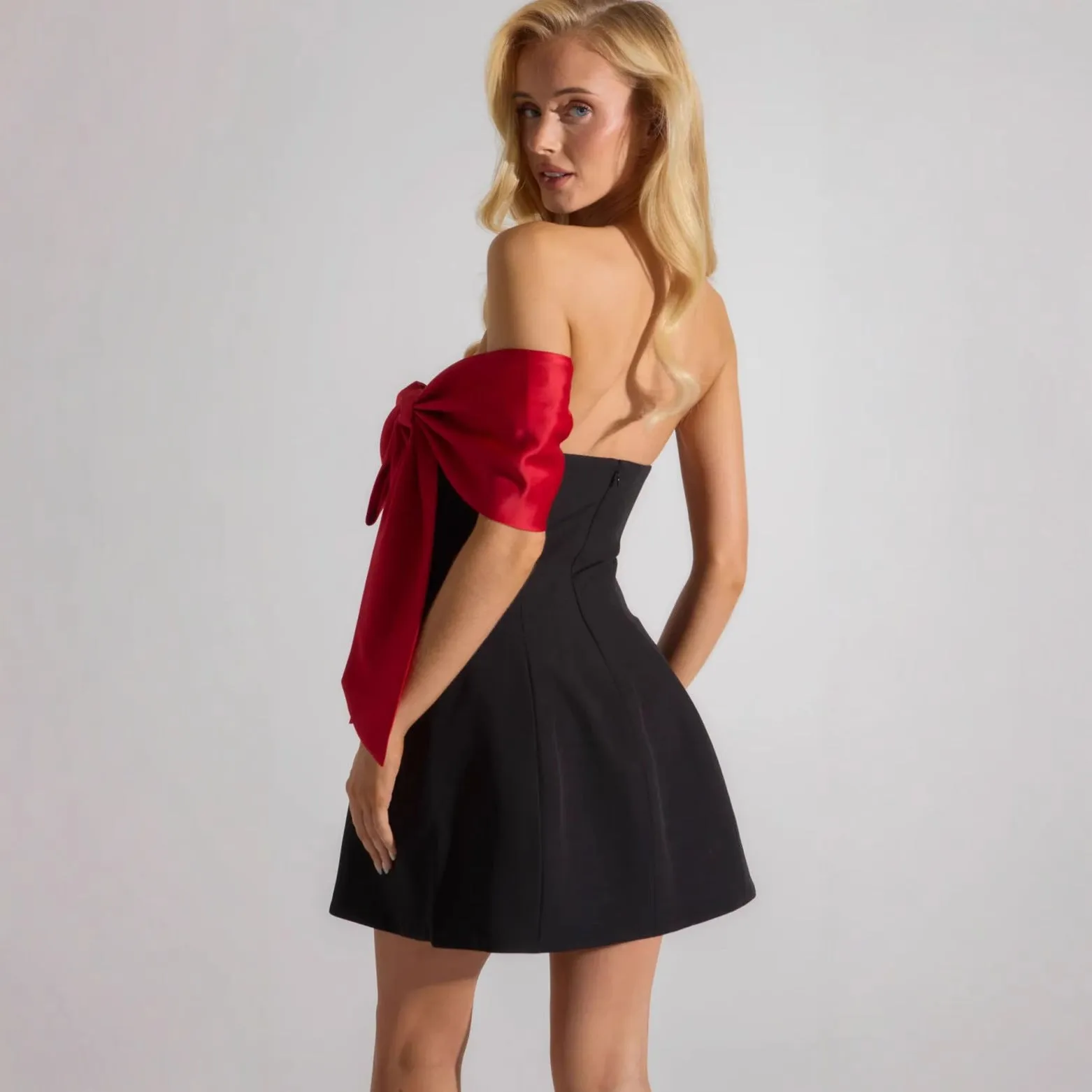Elegant Off-Shoulder Dress with Dramatic Red Bow Accent